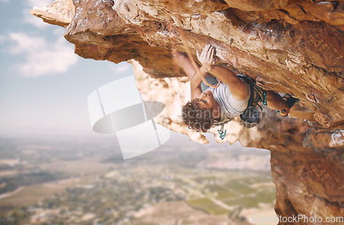 Image of Rock climbing sports and man on mountain cliff for outdoor fitness, wellness goal or workout motivation. Adventure, healthy energy of strong athlete bouldering in safety gear, rope on blue sky nature