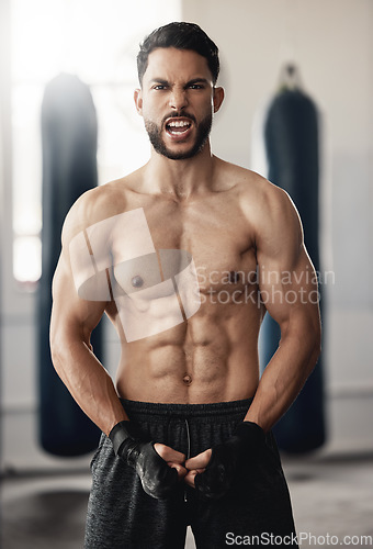 Image of Fitness, sport and man boxer with motivation, vision or exercise goals, health and wellness in gym. Powerful flexing of healthy sports personal trainer with workout for muscle training body in studio