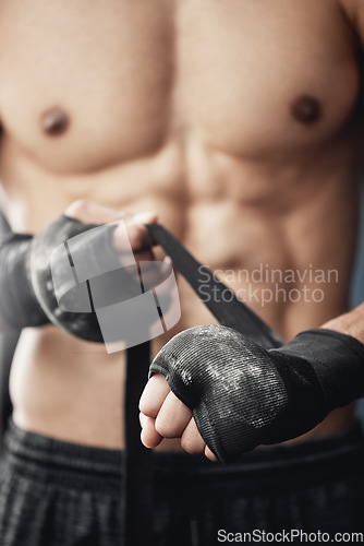 Image of Hands, wrist wrap and boxer man getting ready for tournament fitness workout in boxing gym macro. Training, fighting and mma protection bandage for injury and pain prevention from sports.