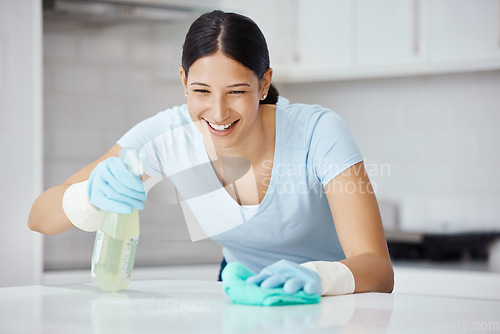 Image of Happy woman cleaning home kitchen, spray product cleaner with safety gloves and polish table with cloth. Domestic happiness, young girl disinfect counter with sanitary detergent and tidy apartment