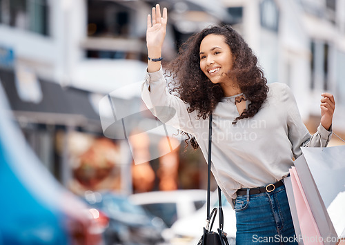 Image of Urban woman, calling taxi and retail bags after positive shopping trip in a busy city. Young girl in the street with store purchase packages while looking for transport service in town.