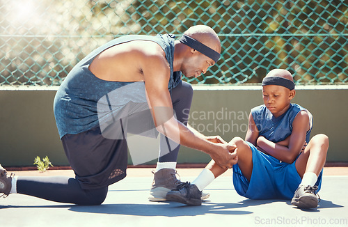 Image of Basketball father and son with knee injury, pain and band aid from sports training leg accident at basketball court. Dad or black man with injured kid emergency plaster for healing wound or bruise