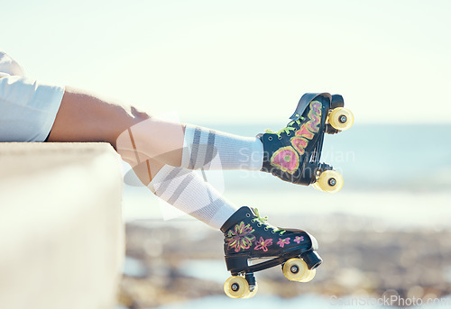 Image of Relax roller skate woman legs at beach, ocean harbor or sea water with holiday fun, freedom and adventure travel. Feet of sports athlete or skater girl with skating shoes for summer outdoor journey