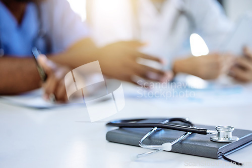 Image of Stethoscope and notebook for cardiology or heart health in hospital meeting background and people discussion of healthcare clinic results. Medical device equipment for consulting or menopause concept