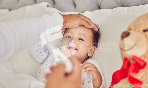 Image of Baby, sick and fever with a mother checking the temperature of a girl lying in bed at home. Family, healthcare and medicine with a daughter feeling ill or unwell and resting in the bedroom of a house