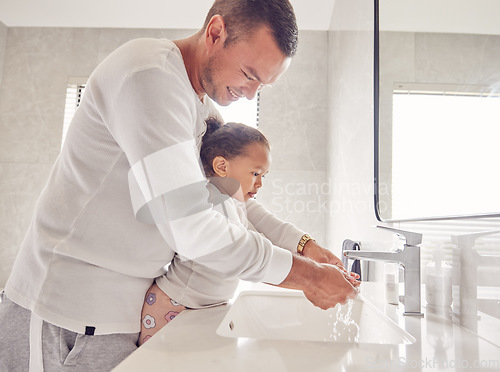 Image of Children, cleaning and family with a man and girl washing their hands in the bathroom at home together. Kids, water and hygiene with a father teaching his daughter about clean and healthy living