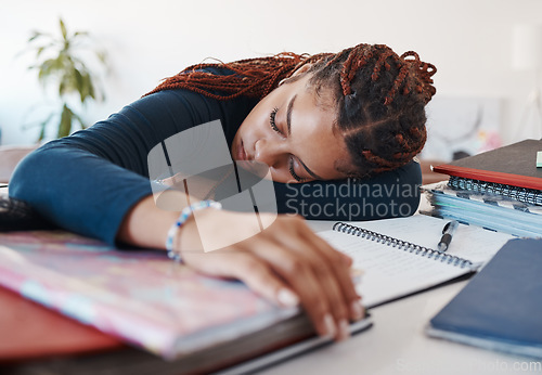 Image of Tired student sleeping at her desk while studying for university or college exams and test. Burnout young woman lying on desk, fatigue or sleep during study session in her living room at home