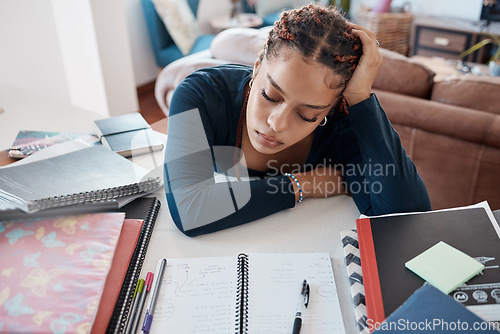 Image of Burnout, tired and fatigue student sleeping at desk while studying for college, school or university exam. Woman scholarship scholar sleep while doing education research for project or assignment