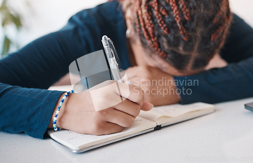 Image of Hand, writing and notebook with an author or writing suffering from stress, anxiety or burnout in her office. Mental, writers block and fatigue with a female journalist or publisher at work