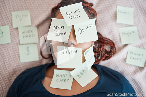 Image of Tired, sticky note and sleeping woman in overworked, schedule or overwhelmed with work and tasks on bed. Female worker covered in paper, pressure and bedroom chaos or information overload at home