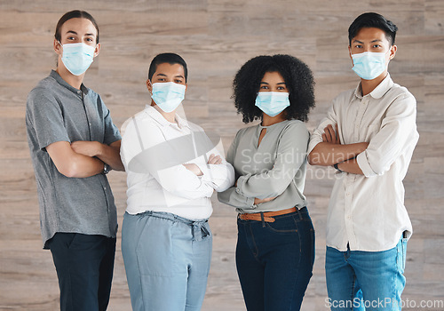 Image of Portrait of diversity team with mask for covid safety, health or protection from bacteria, virus or covid 19. A group of people, staff or workforce standing together in solidarity and support