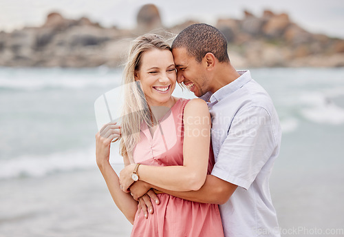 Image of Travel, beach and couple hug, happy and laughing while bonding outdoors, enjoying the view of the ocean. Love, relationship and water fun with relax man and woman on seaside trip in San francisco