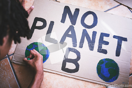 Image of Environment, cardboard and poster for protest for climate change, global warming and earth day. Global, green and ecology with black man drawing a creative sign for environmental and energy crisis