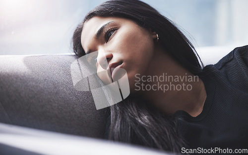 Image of Depression, thinking and sad girl on sofa alone and hopeless with mindset problem in home. Young woman in mental isolation from anxiety, worry and stress about negative thoughts in mind.