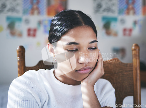 Image of Depression, anxiety and stress by woman thinking and looking sad, sitting and lonely in her bedroom. Young female suffering with mental health problem after a breakup, bad news or suicide thoughts
