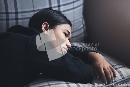 Image of Depression, mental health and woman thinking about a sad memory feeling upset and grief after suffering a loss. Stressed, depressed and disappointed girl worried about a personal problem on the sofa