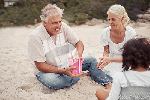 Image of Happy, sand and grandparents playing with their grandchildren at the beach during summer. Positive elderly man and woman building sandcastle with their grandkids by the ocean while on family vacation