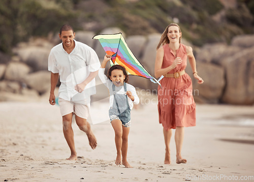 Image of Happy family with child and a kite on the beach in summer for wellness, growth and energy while running together on sand. Love, care and healthy support of mother, father and girl at outdoor holiday