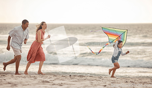 Image of Happy family, beach vacation and child flying kite while running by the sea with her mother and father. Energy, fun and playing while bonding on holiday and summer travel with man, woman and kid