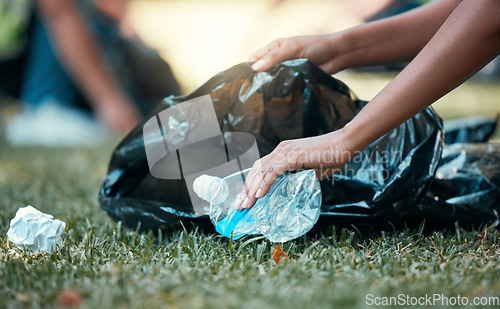 Image of Hands, plastic bottle and recycling volunteer woman cleaning up garbage and environment trash park problem. Sustainability, eco friendly recycle and volunteering girl with sustainable black waste bag