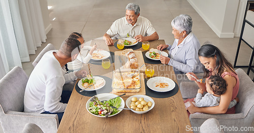 Image of Family, dinner and people from Mexico eating food at a event, holiday celebration or home meal. Talking, conversation and speaking together at the table with kids, grandparents and parents at a house