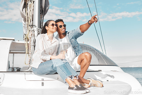 Image of Happy couple, travel and yacht in the ocean for a summer romance on lovely luxury holiday vacation. Smile, sunglasses and young woman enjoying champagne with boyfriend sailing on a cruise date at sea