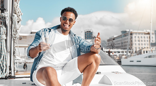 Image of Champagne drink, yacht vacation and man on holiday in Miami, happy on a boat in the sun and international summer. Portrait of African person smile, excited and relax on luxury deck in the sunshine