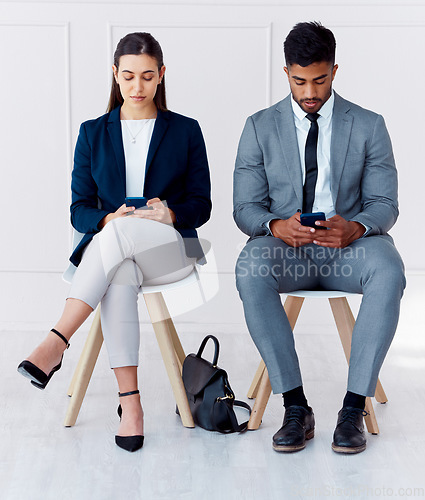 Image of Hiring, interview and phone of businessman and woman with diversity in a office waiting room. Corporate potential workers wait for a company human resources meeting with technology and 5g internet