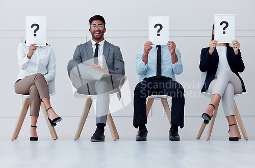 Image of Man at in line at hiring company smile for interview, in waiting room to see manager or boss. Professional male in group of people with question mark paper or posters over face for job recruitment