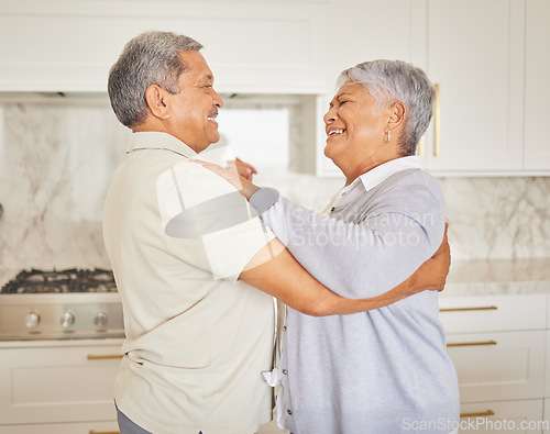 Image of Love, happy and elderly couple dance in a kitchen at home, bonding and having fun. Mature man and woman hug, being playful and loving, enjoying their relationship and retirement together indoors