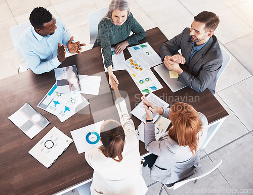 Image of Business handshake, partnership and contract agreement of corporate clients in a meeting room. Crm, b2b and welcome or thank you hand sign of company deal in a marketing presentation with paper data