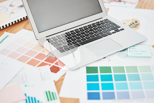 Image of Creative color swatch, laptop planning and paperwork for designer, marketing and advertising strategy on office desk. Background creativity project, art documents and paint catalog for online graphic