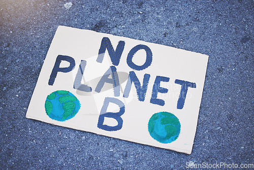 Image of Protest poster, billboard or climate change sign on city street for planet earth, globe or world sustainability. Zoom on abstract cardboard banner in future global warming or eco environment security