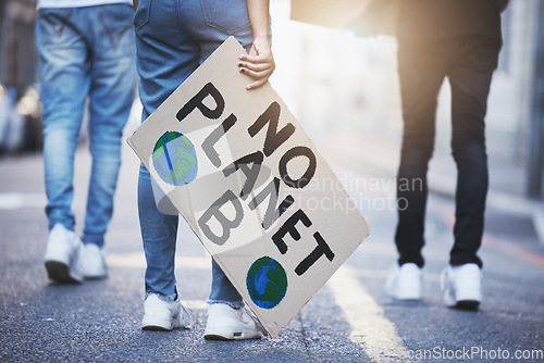 Image of People with climate change poster or banner protest on asphalt road, street or city. Legs of group of women, walk or rally for global warming, world environment change or save the planet with flare