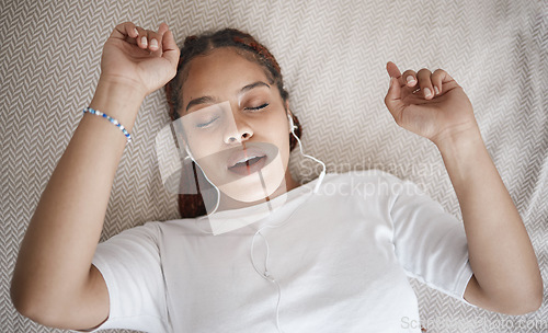 Image of Relax, sleep and bed with woman listening to music while sleeping in her bedroom from above. Radio, podcast and meditation frequency sounds with female using relaxation streaming to help relaxation