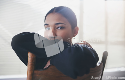 Image of Depression, mental health and anxiety for girl on chair with stress from life, problem and loneliness. Portrait of a sad, lonely and depressed gen z teen woman suffering from mind or mental disorder