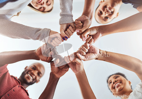 Image of Teamwork, unity and hands or fist for support, trust and community below blue sky. Diversity group men and women friends standing together for teamwork, collaboration and help during team building