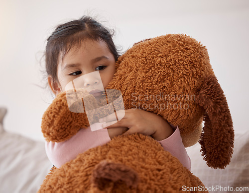 Image of Children, fear and scary with a girl holding her teddy bear after a nightmare in her bedroom at home. Kids, anxiety and depression with a little female child hugging a stuffed animal in her house