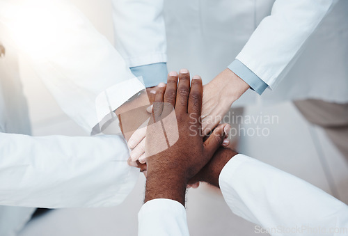 Image of Collaboration, motivation and support with hands of doctors from top view, working in healthcare, vision and innovation. Diversity, teamwork and goals with group of medical professionals for trust