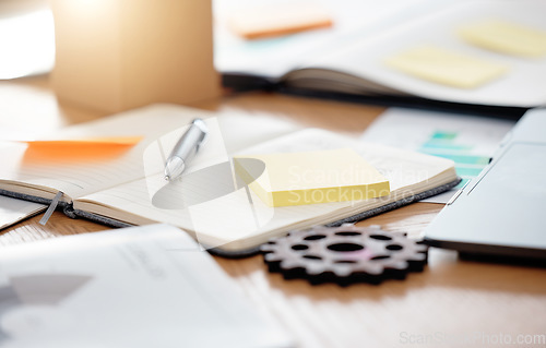 Image of Table, paperwork and sticky note planning, strategy and brainstorming notebook at an office. Business work desk of gadgets for scheduling, ideas and writing notes for project data and information