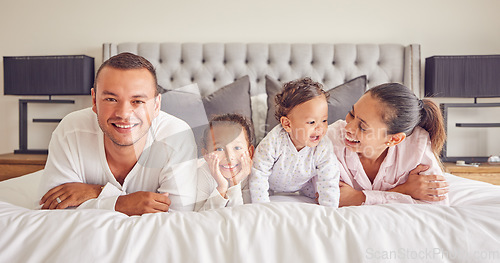 Image of Portrait of family in home bedroom, young kids smile on bed and mother laughing with girl baby happiness. Face of happy father, morning cuddle together and funny mama relax in pyjamas on weekend rest