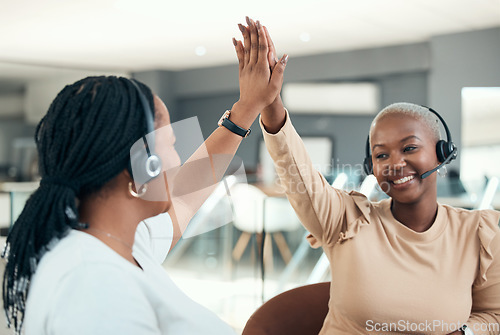 Image of High five, call center and teamwork with women celebrating and happy about success, target and goal working in telemarketing office. Black CRM, customer support and service agents in collaboration