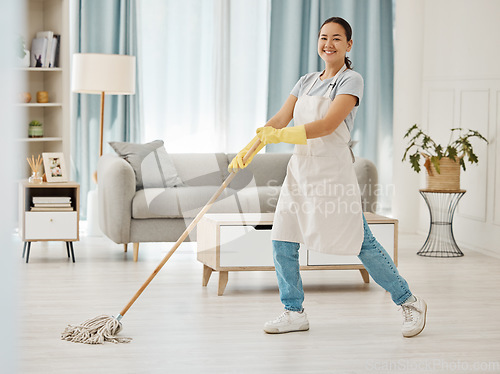 Image of Asian cleaner woman mopping and cleaning dirt and dust in lounge or living room floor in house or home. Happy Japanese housekeeping help, hygiene maid or employee tidy and spring cleaning apartment