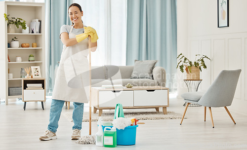 Image of Happy woman cleaning home floor, house work and smile in home service mopping living room, job with gloves and happy to clean house apartment. Portrait of Asian cleaner or housewife housekeeping