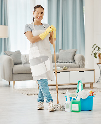 Image of Cleaning floor, house work and woman working in home service mopping living room, doing job with smile and happy to clean house apartment. Portrait of Asian cleaner or housewife housekeeping