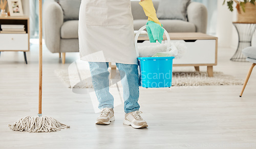 Image of Legs of home cleaning woman with house equipment, mop and bucket for floor hygiene, dust and dirt. Girl, cleaner or worker doing interior house cleaning service with living room cleanliness detergent