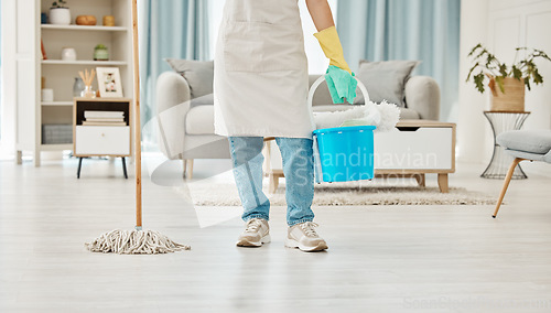 Image of Cleaning, mop and spring cleaning equipment with woman in living room for domestic, hygiene and sanitary. Maid or housekeeper with container in home for interior, house or apartment cleaning service