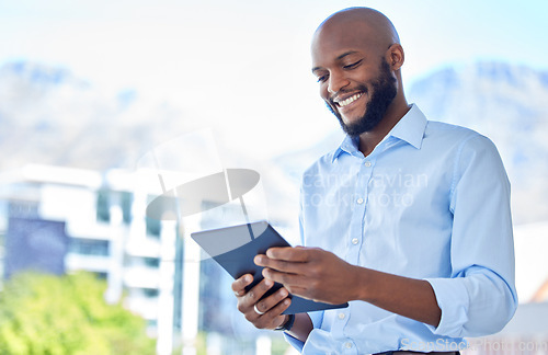 Image of Businessman with digital tablet and happy with business progress, profit and growth while alone on office balcony. Male smile corporate executive using technology to plan success or innovate idea