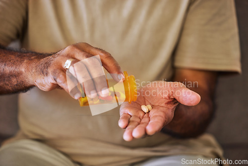 Image of Medicine, healthcare and pills in the hands of a senior man sitting on a sofa in the retirement home. Prescription, medication and antibiotics for chronic treatment and wellness with a pensioner