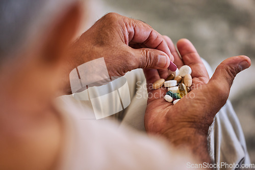 Image of Pills, medicine and healthcare of senior man taking daily capsules for chronic illness, cancer or health. Wellness, medication and sick elderl with medical drugs, vitamins or supplements in his hand